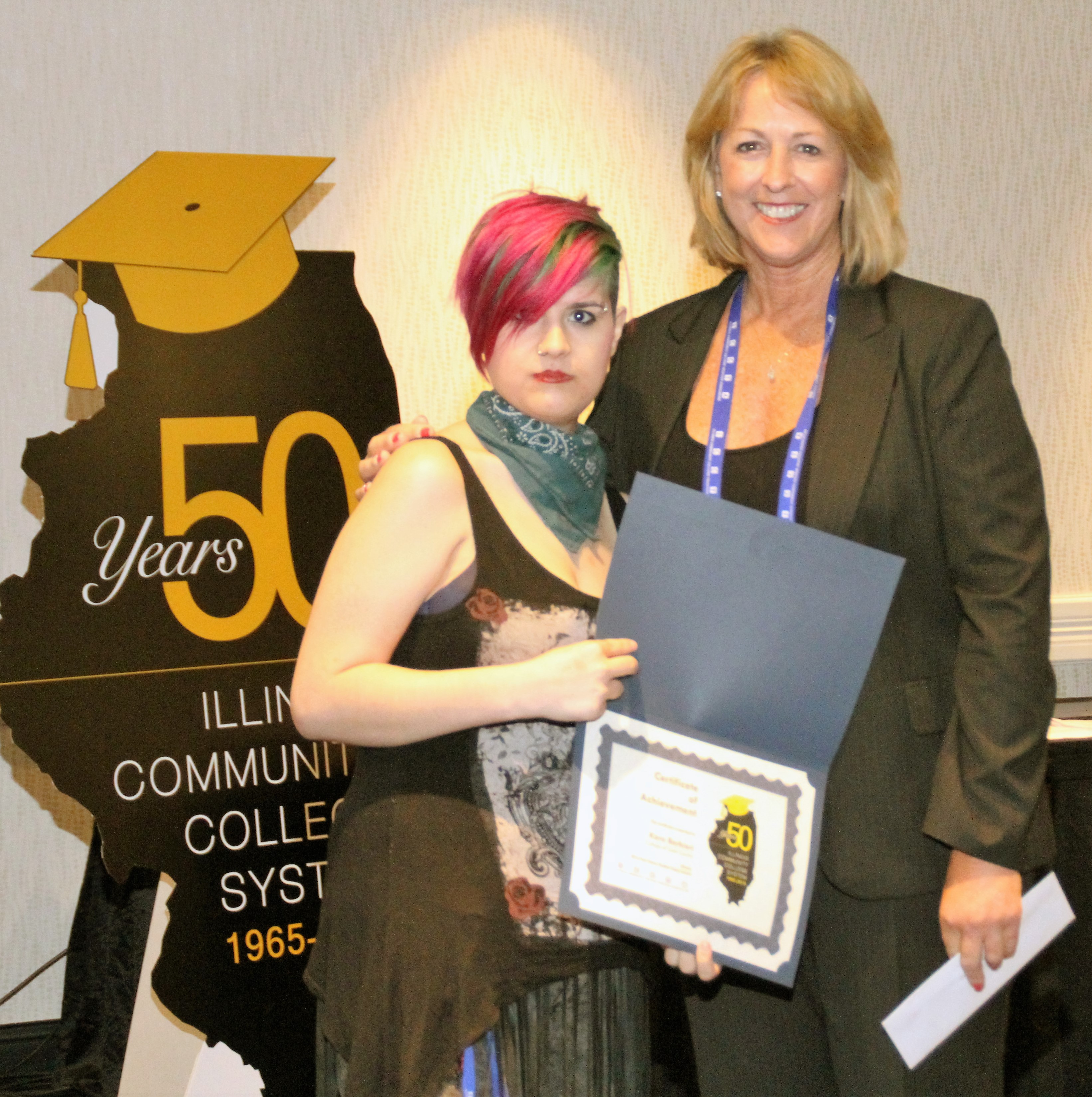 College of Lake County student Kara Barbieri accepts her $500 Paul Simon Student Essay Contest scholarship
from ICCTA vice president Linda Liddell.