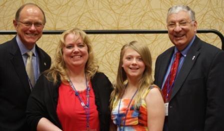 Rock Valley College student Rebecca Hines (second from left) accepts her $500 Paul Simon Student Essay Contest scholarship from RVC president Jack Becherer, her daughter Hannah, and ICCTA president Jim Ayers.