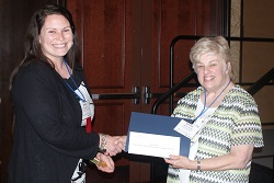 Heartland Community College student Sara Keene (left) accepts her $250 Paul Simon Student Essay Contest scholarship
from ICCTA secretary Kathy Spears.