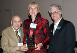 Elgin Community College trustee Dr. Clare Ollayos (middle)
receives ICCTA's 2009 Ray Hartstein Trustee Achievement Award from ICCTA Honorary Member Ray Hartstein (left) 
and ICCTA president Jeff May.