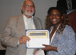 John A. Logan College student Jor'Dan Crim accepts her $1,000 Gandhi/King Peace Essay Scholarship
from Oakton Community College trustee emeritus Jody Wadhwa.