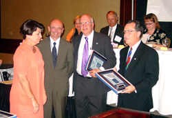 Sharon Tarvin (left) and Don Crist (second from left) receive their ICCTA Certificates of Merit from executive director Gary Davis and president-elect Jack Daley.